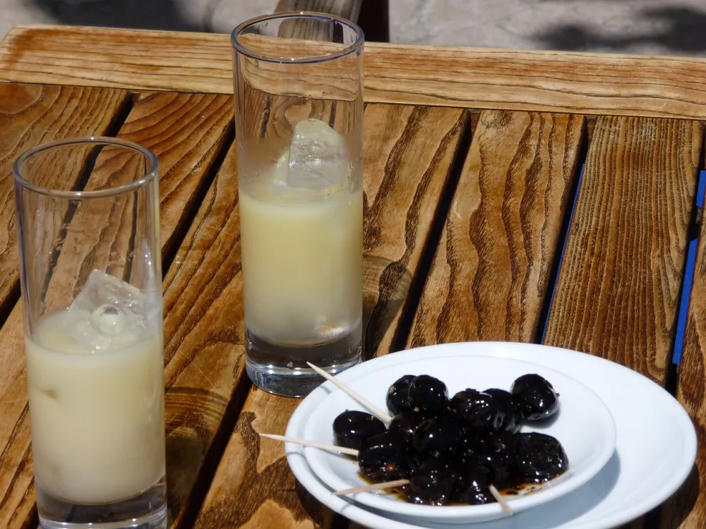 Popular pastis with ice and olives